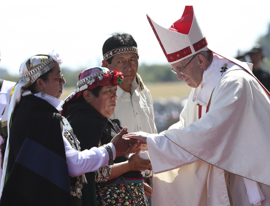 Pope Francis greets Mapuches in an offertory of a Mass at the Maquehue Air Base, in Temuco, Chile, on Wednesday. Francis is urging the Mapuche people to reject violence in pushing their cause. Francis made the comments Wednesday while celebrating Mass in Temuco. The city is the capital of the Araucania region, where many of Chile’s estimated 1 million people of Mapuche descent live.