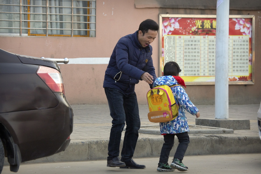 Chinese labor activist Hua Haifeng, adjusts the backpack of his son, Bo Bo, 4, as he takes him to school on the outskirts of Xiangyang in central China’s Hubei Province. Apple Inc. and Ivanka Trump’s brand both rely on Chinese suppliers that have been criticized for workplace abuses. But they’ve taken contrasting approaches to dealing with supply chain problems. When Apple learned thousands of student workers at an iPhone supplier had been underpaid, it helped them get their money back. After three men investigating labor abuses at factories that made Ivanka Trump shoes were arrested last year, neither Ivanka Trump nor her brand spoke out.