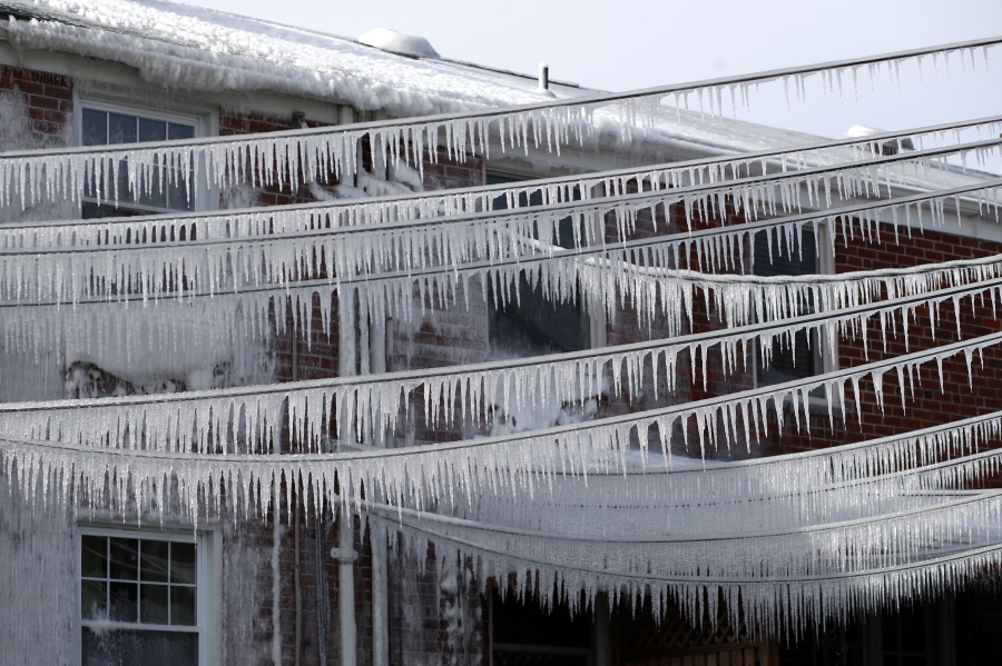 Icicles cling to power lines behind rowhomes Wednesday in Catonsville, Md.,.