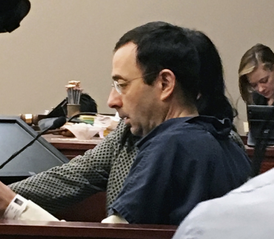 Former Michigan sports doctor Larry Nassar sits in court Tuesday in Lansing, Mich., at the start of his four-day sentencing hearing for sexually assaulting young gymnasts. Dozens of women and girls who were victims will be allowed to speak. Judge Rosemarie Aquilina is expected to order a sentence Friday, Jan. 19.