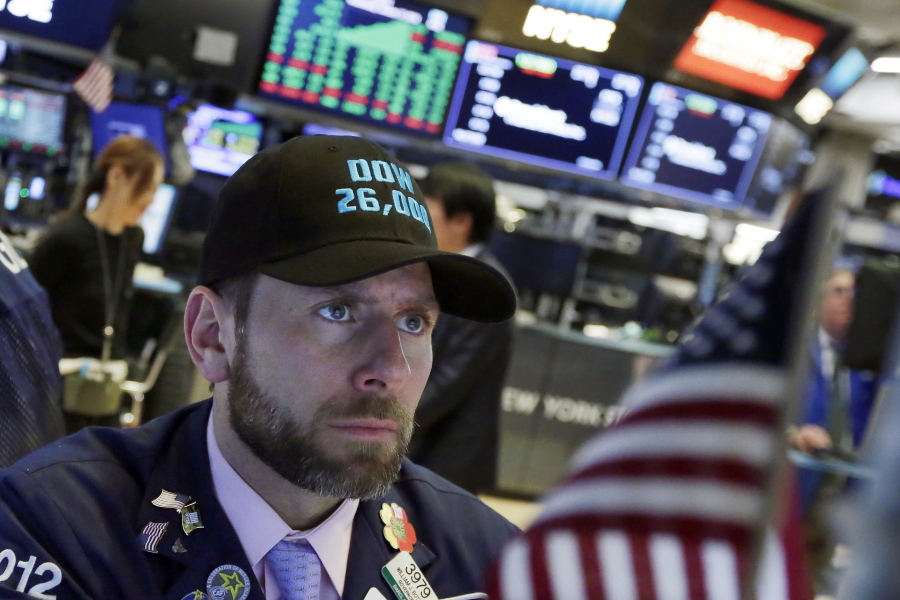 Specialist Michael Pistillo wears a “Dow 26,000” hat as he works on the floor of the New York Stock Exchange, Wednesday, Jan. 17, 2018. Stocks are closing higher on Wall Street, sending the DJIA to its first close above 26,000 points.