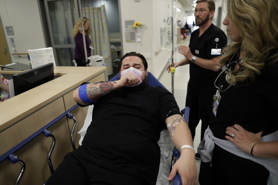 Donnie Cardenas recovers from the flu at the Palomar Medical Center in Escondido, Calif., on Wednesday, Jan. 10, 2018. The San Diego County resident said he was battling a heavy cough for days before a spike his temperature sent him into the emergency room.