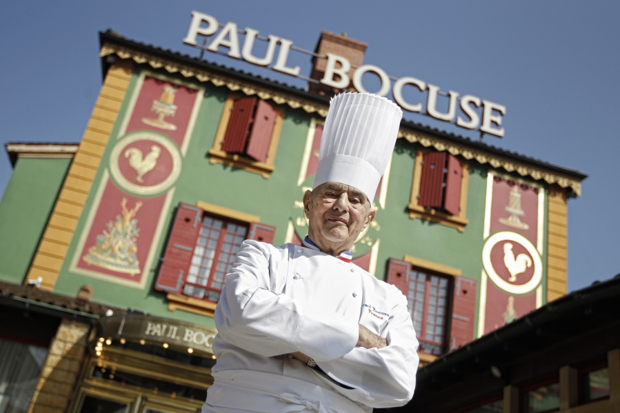 French Chef Paul Bocuse poses outside his famed Michelin three-star restaurant L’Auberge du Pont de Collonges in Collonges-au-Mont-d’or, central France. French interior minister announces Saturday Bocuse, a master of French cuisine, has died at 91.