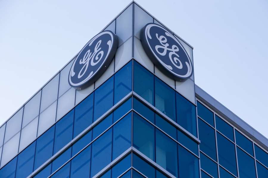 The General Electric logo is displayed at the top of their Global Operations Center, Tuesday, Jan. 16, 2018, in the Banks development of downtown Cincinnati. GE CEO John Flannery, who was put in charge of reviving the company last summer, revealed significant issues at GE Capital on Tuesday, which will lead to a $6.2 billion after-tax charge in the fourth quarter.