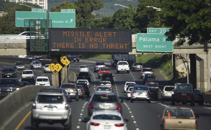 Cars drive Saturday past a highway sign that says “MISSILE ALERT ERROR THERE IS NO THREAT” on the H-1 Freeway in Honolulu. The state emergency officials announced human error as cause for a statewide announcement of an incoming missile strike alert that was sent to mobile phones.