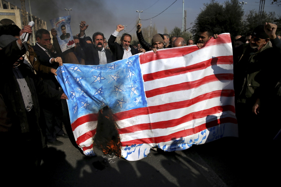 Iranian worshippers chant slogans while they burn a representation of U.S. flag during a rally against anti-government protestors after the Friday prayer ceremony in Tehran, Iran, Jan. 5, 2018. A hard-line Iranian cleric has called on Iran to create its own indigenous social media apps, blaming them for the unrest that followed days of protest in the Islamic Republic over its economy.