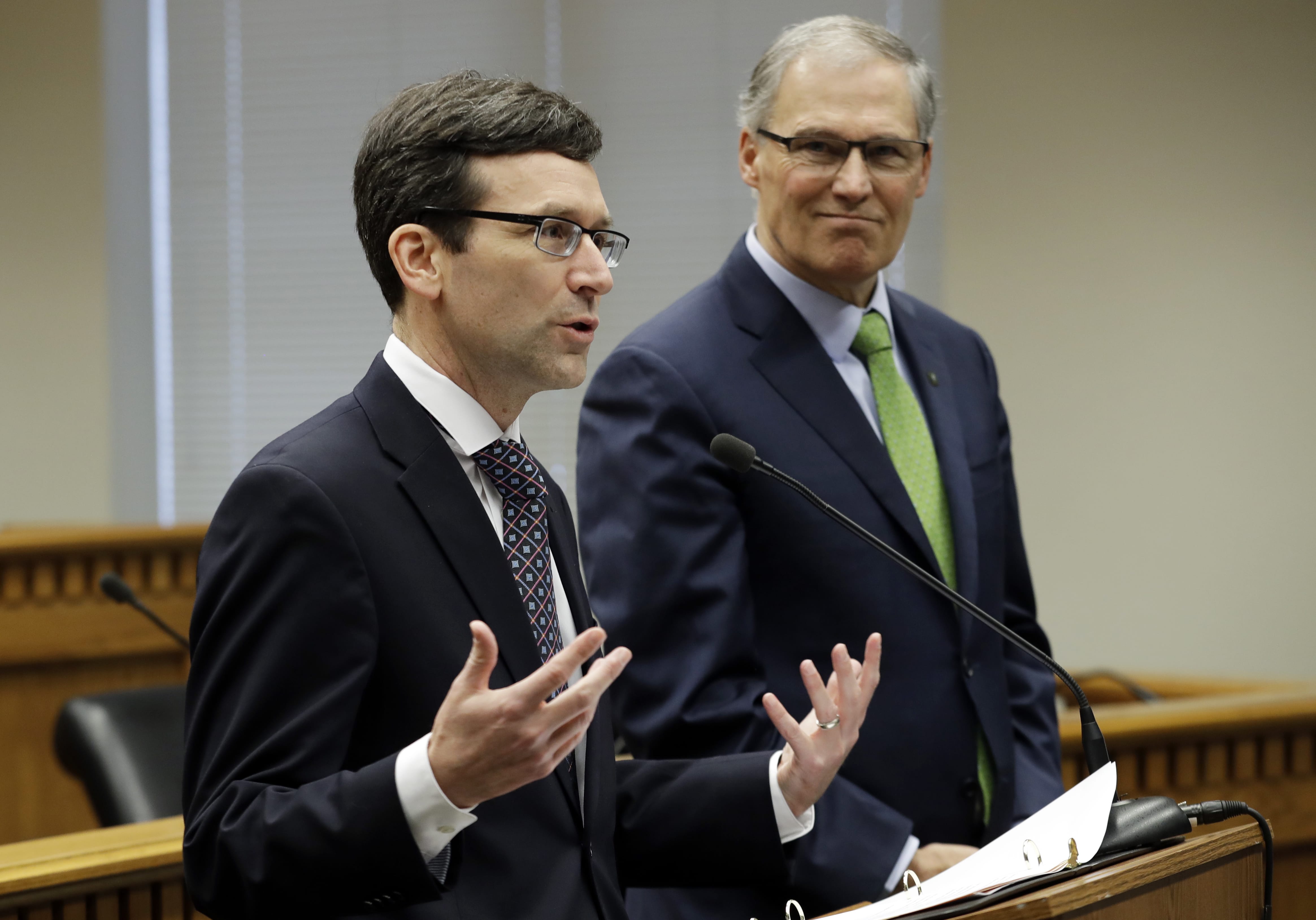 Washington Attorney General Bob Ferguson, left, talks to reporters as Washington Gov. Jay Inslee looks on Jan. 4 at the Capitol in Olympia. Ferguson is among the state attorneys general who signed the petition to bring back net neutrality. (AP Photo/Ted S.