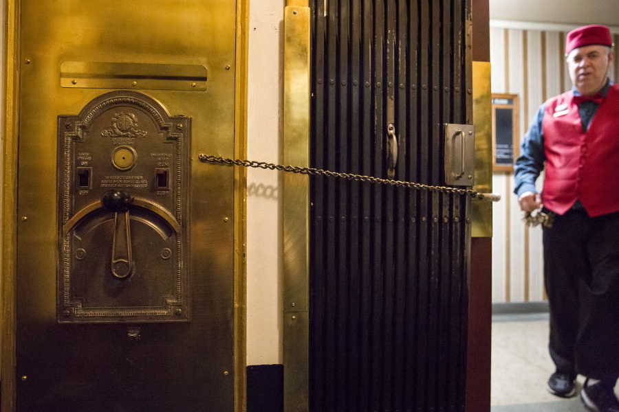 A chain holds the gate and door open to the elevator at the Oregon Bank Building in Klamath Falls, Ore., Jan. 10. David Filippe, head elevator operator at the historic Oregon Bank Building, said the nearly 87-year-old elevator is one of five manually operated lifts on the West Coast.