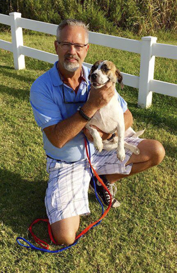 Dr. Bill Kinsinger, with Rascal, a dog from Fort Worth Animal Care & Control, in Gainesville, Texas. Official said Thursday that Kinsinger, a doctor volunteering for a dog rescue operation who failed to land his small plane at an airport in Central Texas as planned and was later tracked by fighter jets flying over the Gulf of Mexico appeared unresponsive and may have been suffering from a lack of oxygen. A Federal Aviation Administration spokesman said the plane kept flying and was last observed on radar 219 miles northwest of Cancun, Mexico, flying at 15,000 feet. Kinsinger took off from Wiley Post Airport in Oklahoma City Wednesday afternoon after filing a flight plan to land in Georgetown, Texas.
