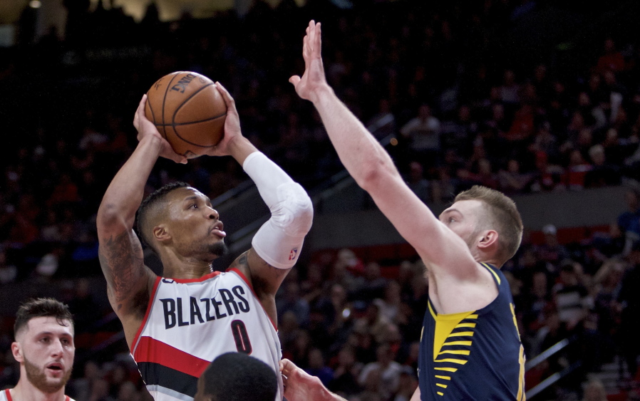 Portland Trail Blazers guard Damian Lillard shoots over Indiana Pacers center Domantas Sabonis during the second half of an NBA basketball game in Portland, Ore., Thursday, Jan. 18, 2018. The Trail Blazers won 100-86.
