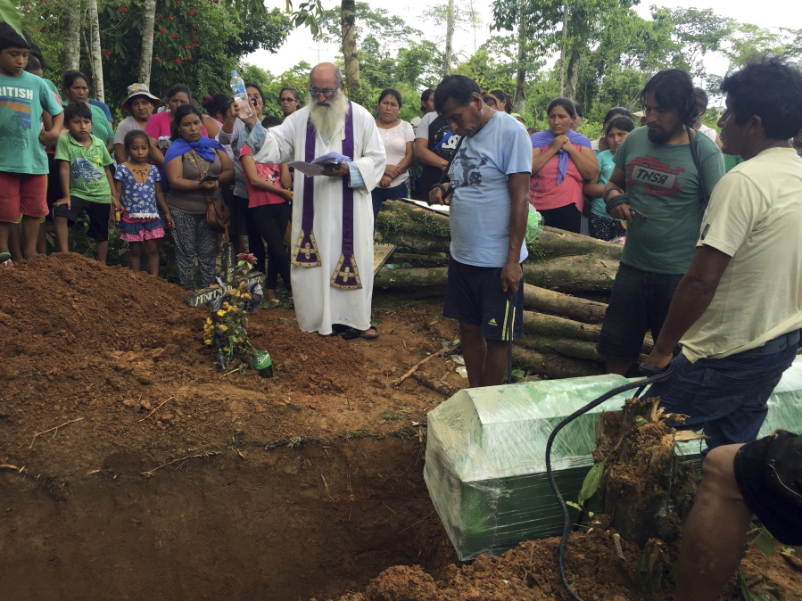 Father Pablo Zabala presides Jan. 6 over a burial service for miner Juan Peralta at the Delta 1 cemetery, in Peru’s Madre de Dios region. The Spanish priest, 70, tends to some of the rainforest’s most hapless souls, such as Juan Peralta, who was shot dead in a dispute with an indigenous tribe.