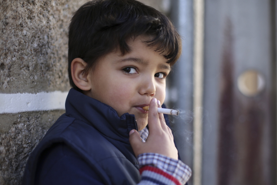 Fernando, 6-years-old, smokes a cigarette in the village of Vale de Salgueiro, northern Portugal, during the local Kings’ Feast Saturday, Jan. 6, 2018. The village’s Epiphany celebrations, called Kings’ Feast, feature a tradition that each year causes an outcry among outsiders: parents encourage their children, some as young as 5, to smoke cigarettes. Parents buy the packs of cigarettes for their children. Locals say the practice is centuries-old, but nobody is sure what it symbolizes nor why the children are incited to smoke.
