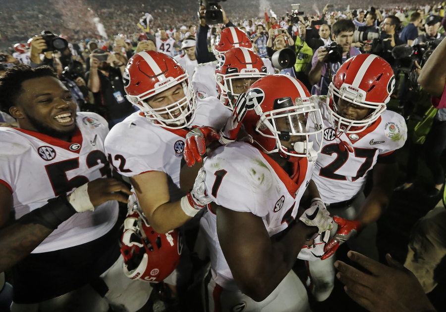 Georgia tailback Sony Michel (1) celebrates with teammates after scoring the game-winning touchdown in the second overtime period to give Georgia a 54-48 win over Oklahoma in the Rose Bowl NCAA college football game, Monday, Jan.
