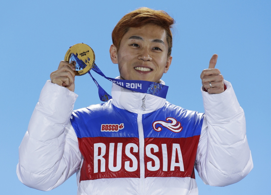 Men’s 1,000-meter short track speedskating gold medalist Viktor Ahn, of Russia, gestures while holding his medal during the medals ceremony at the Winter Olympics in Sochi, Russia, in 2014. The Russian Olympic Committee says Ahn, a six-time Olympic gold medalist, is among several top Russian athletes barred from the upcoming Pyeongchang Olympics amid the country’s ongoing doping scandal. (AP Photo/David J.
