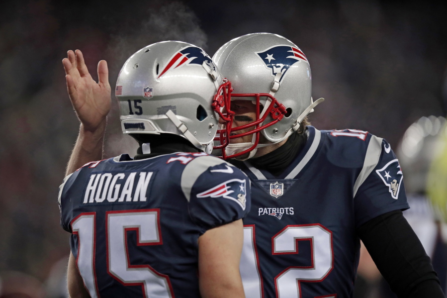 New England Patriots quarterback Tom Brady, right, celebrates his touchdown pass to Chris Hogan during the first half of an NFL divisional playoff football game against the Tennessee Titans, Saturday, Jan. 13, 2018, in Foxborough, Mass.