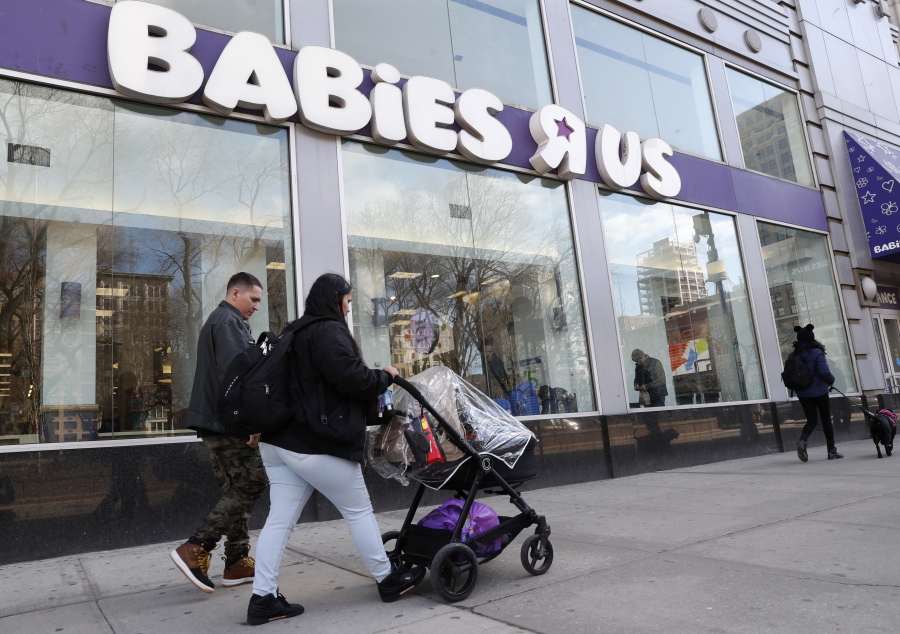Queens residents Carlos Lopes, left, and Katiria Maldonado and their young child leave Babies R Us after shopping at Manhattan’s Union Square store in New York, Wednesday, Jan. 24, 2018. The couple said they were “shocked” to hear about the store’s closing. Toys R Us, which owns Babies R Us, has been squeezed by Amazon.com and huge chains like Walmart. The company will close 180 stores, or about 20 percent of its U.S. locations, within months. Some Toys R Us locations will be combined with Babies R Us.