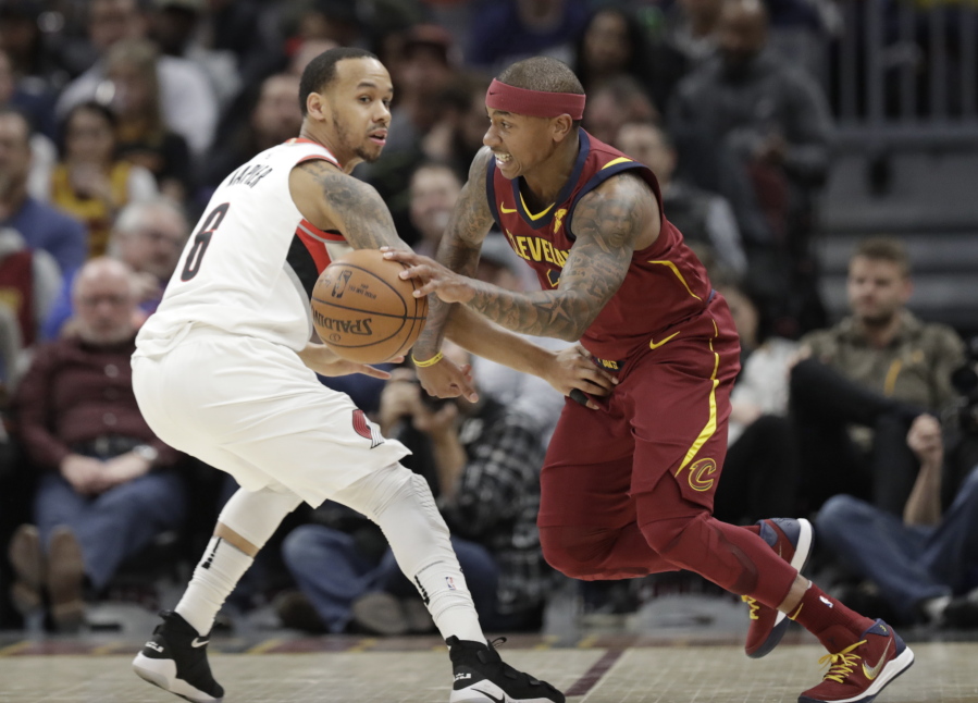 Cleveland Cavaliers’ Isaiah Thomas, right, drives past Portland Trail Blazers’ Al-Farouq Aminu in the first half of an NBA basketball game, Tuesday, Jan. 2, 2018, in Cleveland.