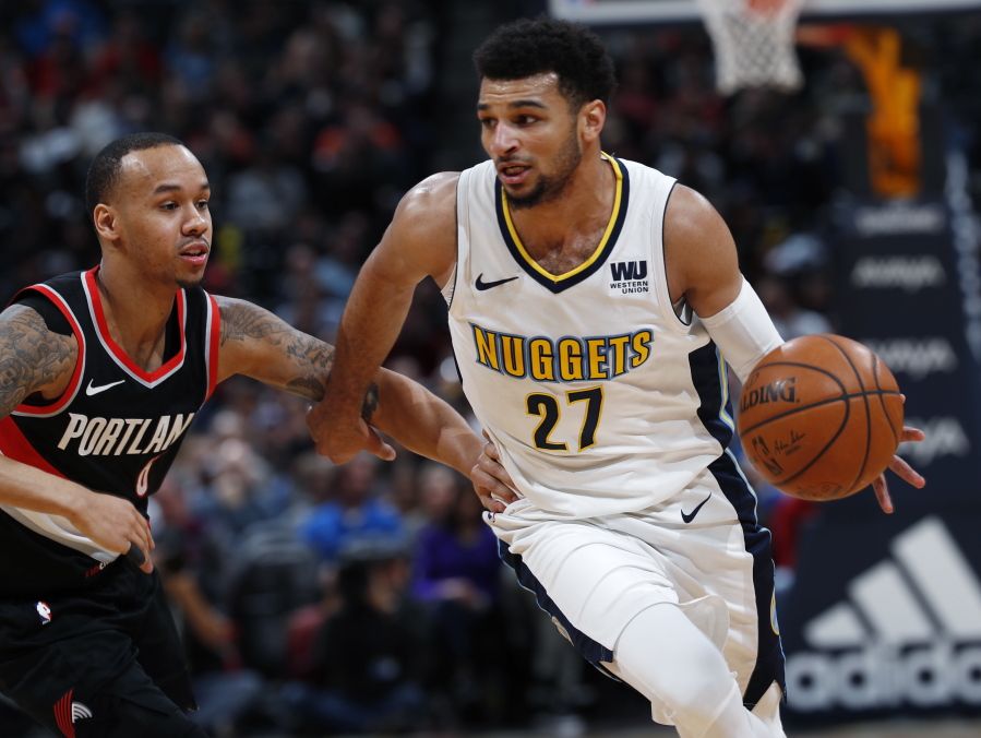 Portland Trail Blazers guard Shabazz Napier, left, defends as Denver Nuggets guard Jamal Murray drives the lane to the rim in the first half of an NBA basketball game Monday, Jan. 22, 2018, in Denver.