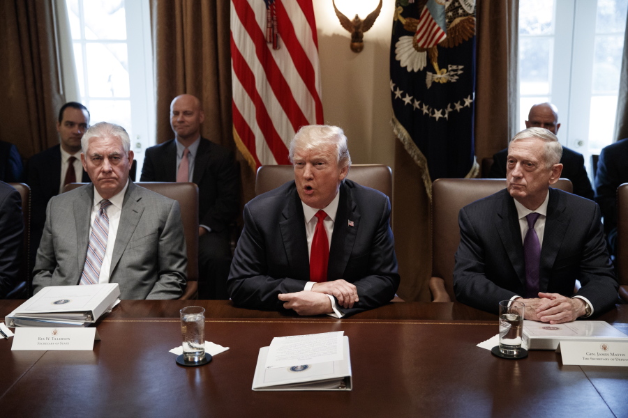 Secretary of State Rex Tillerson, left, and Secretary of Defense Jim Mattis, right, listen as President Donald Trump speaks during a cabinet meeting at the White House on Wednesday in Washington.