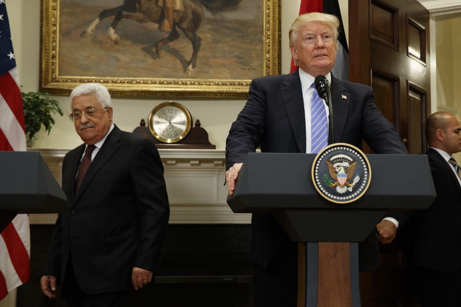 FILE - In this May 3, 2017 file photo, President Donald Trump and Palestinian Authority President Mahmoud Abbas arrive in the Roosevelt Room of the White House in Washington. With a Twitter post on Tuesday, Jan. 2, 2018, threatening to cut off U.S. aid to the Palestinians, Trump has expressed his frustration over the lack of progress in his hoped-for Mideast peace push. But things could deteriorate even further if Trump follows through on the threat.
