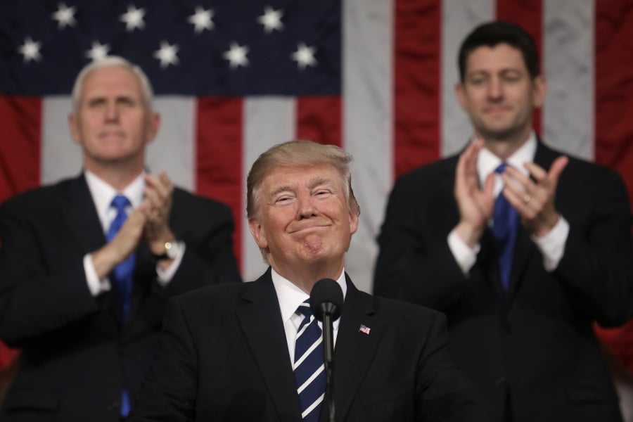 President Donald Trump addresses a joint session of Congress on Capitol Hill in Washington, as Vice President Mike Pence and House Speaker Paul Ryan of Wis., applaud. President Trump’s first state of the union speech will carry more suspense than most.