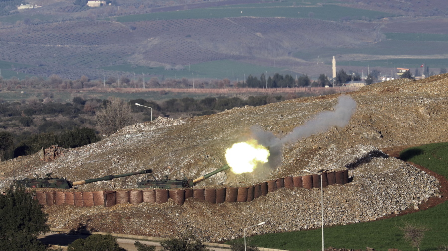In this photo taken Friday, Jan. 19, 2018, Turkish artillery fire toward Syrian Kurdish positions from the Turkish side of the border, in Hatay, southern Turkey.