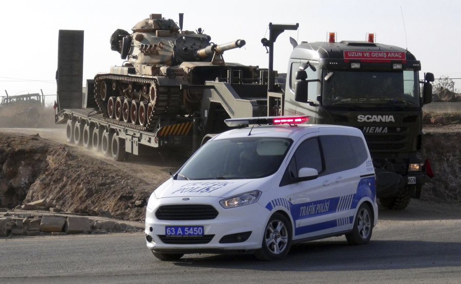 Police on Wednesday escort a tank-loaded truck heading to the border with Syria, in Sanliurfa, Turkey.