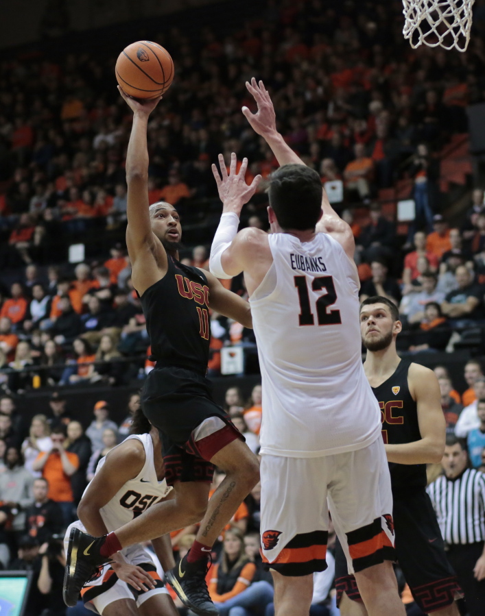 Southern California’s Jordan McLaughlin (11) shoots over Oregon State’s Drew Eubanks (12) in the first half of an NCAA college basketball game in Corvallis, Ore., Saturday, Jan. 20, 2018. (AP Photo/Timothy J.
