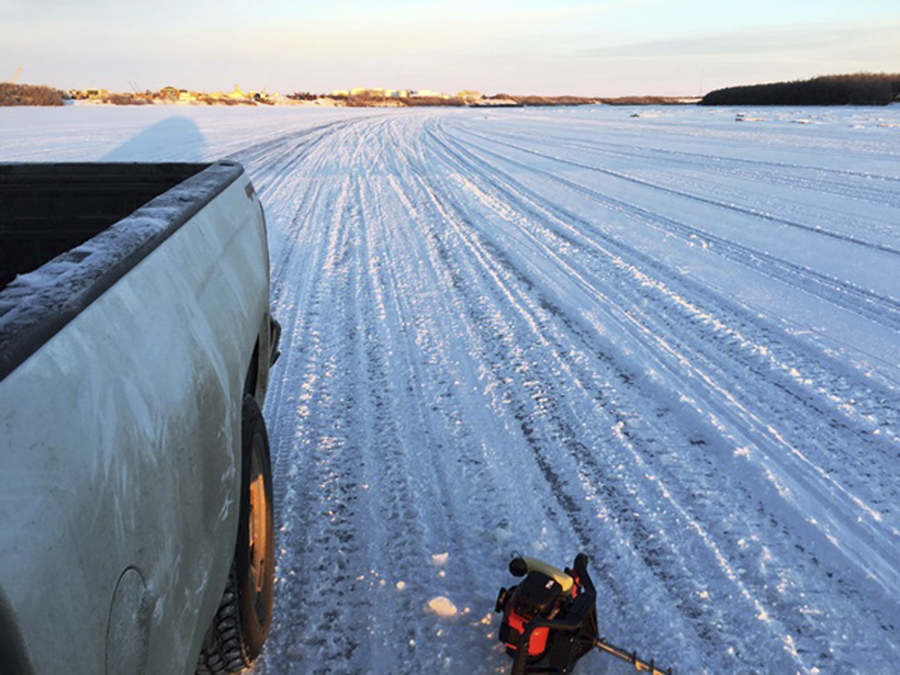 This January, 2018 photo provided by Bethel Search and Rescue shows a truck on a well-used track on a portion of the Kuskokwim River near Bethel, Alaska. The river is not covered by as much ice as it usually is this time of year. Months of higher-than-normal temperatures have opened dangerous holes in frozen rivers that rural Alaskans use as roads. One troublesome ice highway is the Kuskokwim River, where a man died New Year’s Eve after driving his snowmobile into a hole.