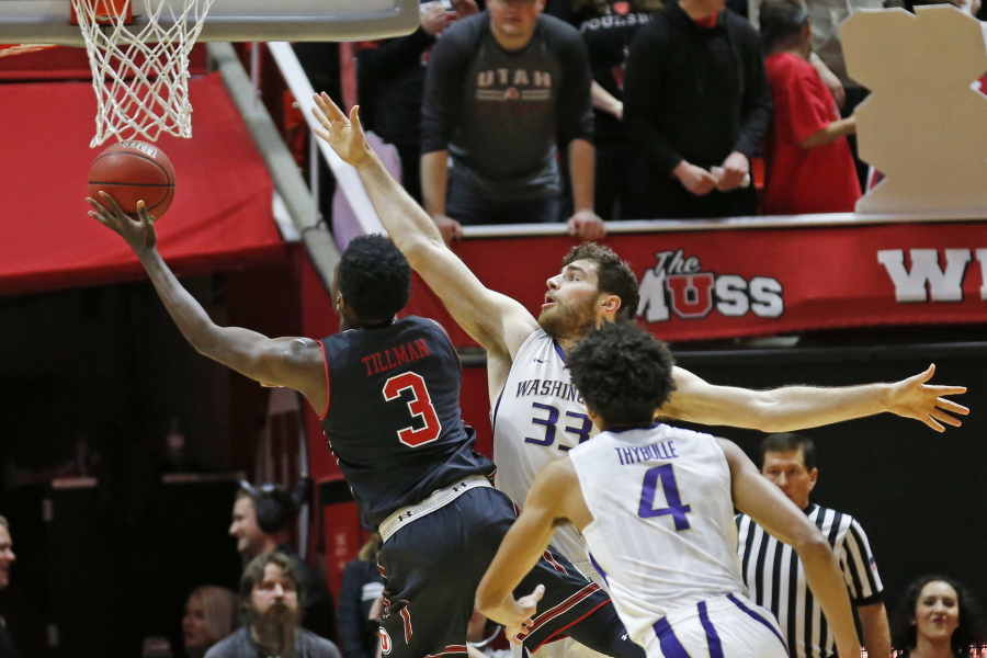 Utah forward Donnie Tillman (3) goes to the basket as Washington forward Sam Timmins (33) defends in the first half during an NCAA college basketball game Thursday, Jan. 18, 2018, in Salt Lake City.
