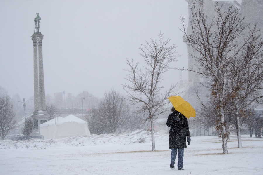 Sarah Wilson walks down the hill along Kellogg Avenue in St. Paul,. Minn., with an umbrella to shield the wind and snow Monday, Jab. 22, 2018. “I walk every day no matter the weather,” said Wilson. The Minnesota Department of Transportation is advising against traveling in portions of southwest Minnesota because of white out conditions. The visibility issue extends from Worthington east to Albert Lea and north to Mankato. The roadways involved include portions of Highway 30, Highway 91 and Highway 59. A blizzard warning is in effect for much of south central and southeastern Minnesota.