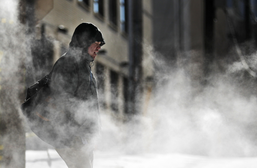 A man walks through steam venting from a building in the cold weather in Atlanta, Wednesday, Jan. 17, 2018. The South awoke on Wednesday to a two-part Arctic mess. First came a thin blanket of snow and ice, and then came the below-zero wind chills and record-breaking low temperatures in New Orleans and other cities.