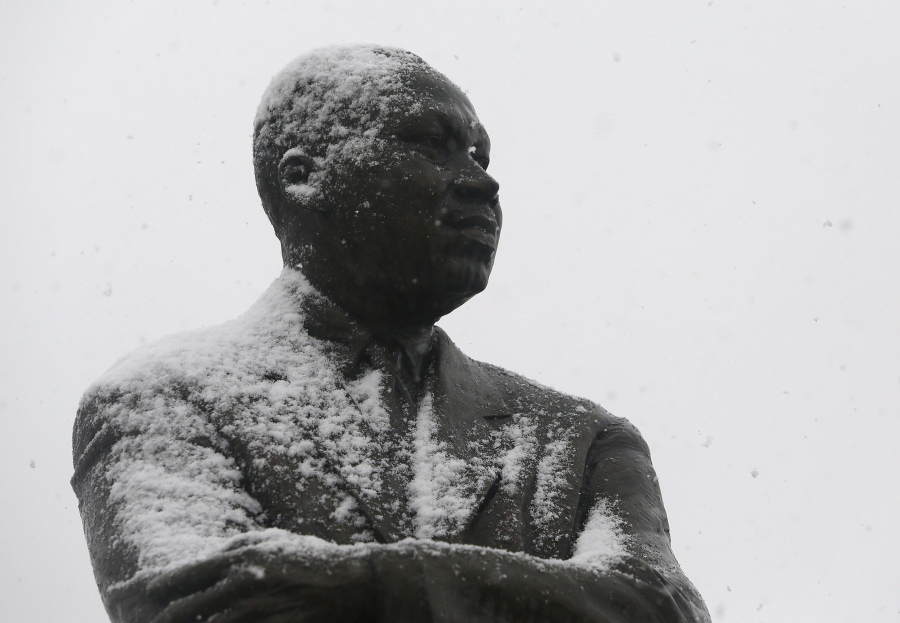 Snow begins to accumulate on the statue of Martin Luther King Jr. as flurries fall at Martin Luther King Jr. Park, Wednesday, Jan. 17, 2018, in Rocky Mount, N.C.