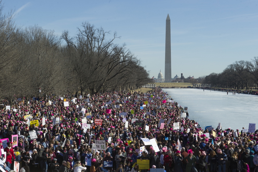 Participants in the Women’s March gather near the Lincoln Memorial in Washington, Saturday. On the anniversary of President Donald Trump’s inauguration, people participating in rallies and marches in the U.S. and around the world Saturday denounced his views on immigration, abortion, LGBT rights, women’s rights and more.