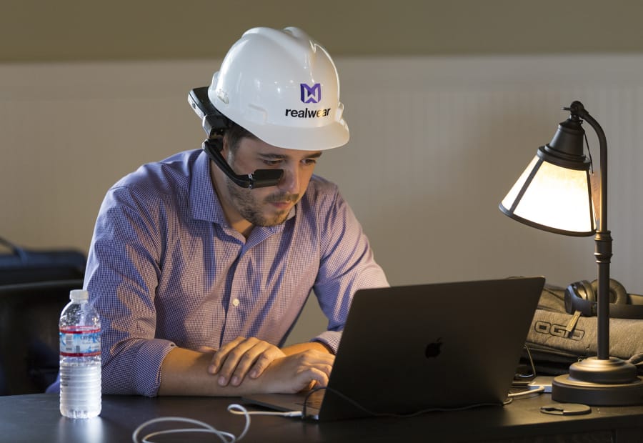 RealWear netted $17 million in investment near the end of January, according to filings with the Securities and Exchange Commission. An employee wears its head-mounted tablet while working last September.