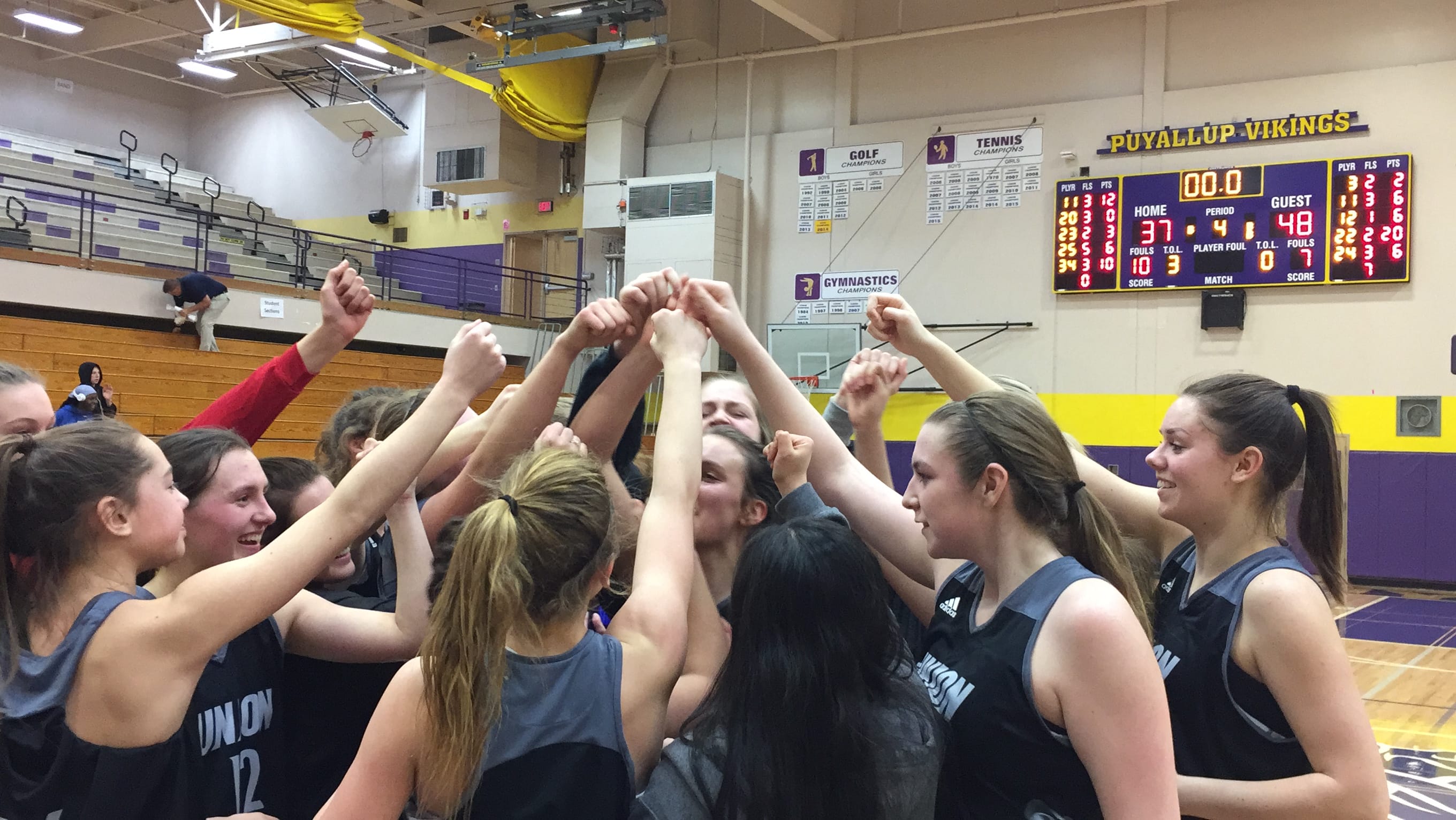The Union girls basketball team celebrates a 48-37 victory over Todd Beamer in the regional round of the Class 4A state tournament on Friday in Puyallup.