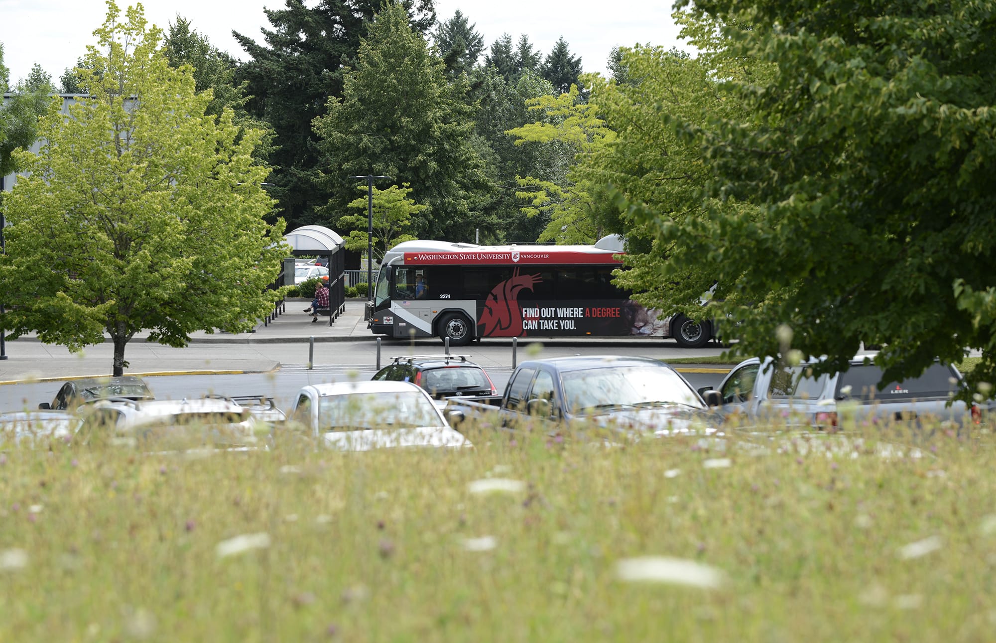 A C-Tran bus is seen in July from an empty field at Fisher's Landing Transit Center, where C-Tran is planning to build a new transit-oriented development.