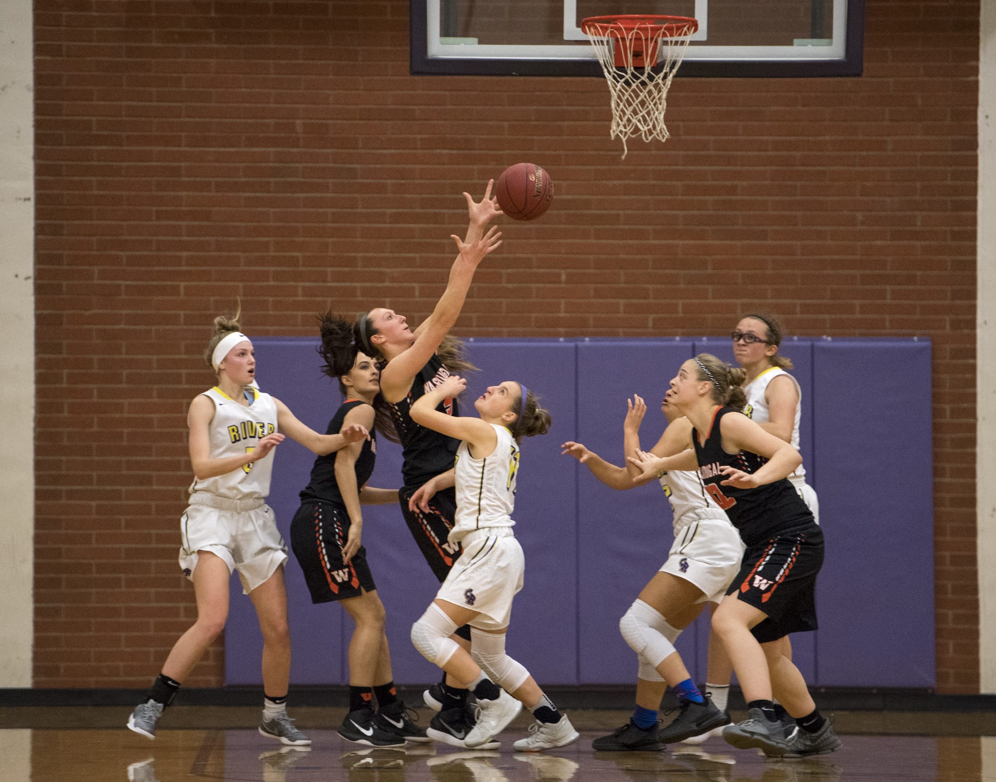 Washougal's Beyonce Bea (5) leaps up for a defensive rebound during Thursday night's game at Columbia River High School on Feb. 1, 2018. Washougal won 54-53.