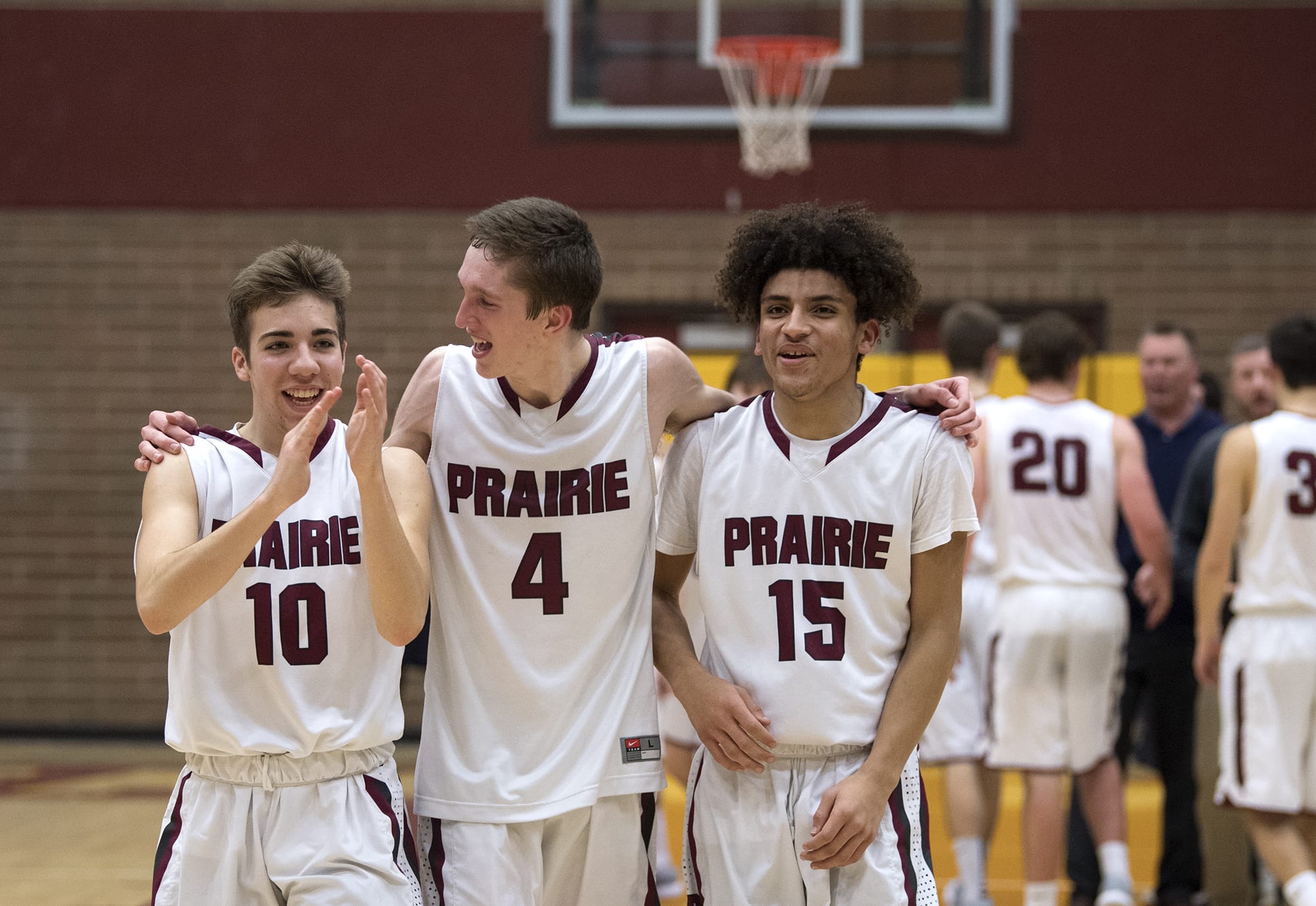 Prairie's Thomas Hapgood (10), Braiden Broadbent (4), and A.J. Dixon (15) celebrate their win after Friday night's game against Kelso at Prairie High School in Vancouver. Prairie won 64-55.