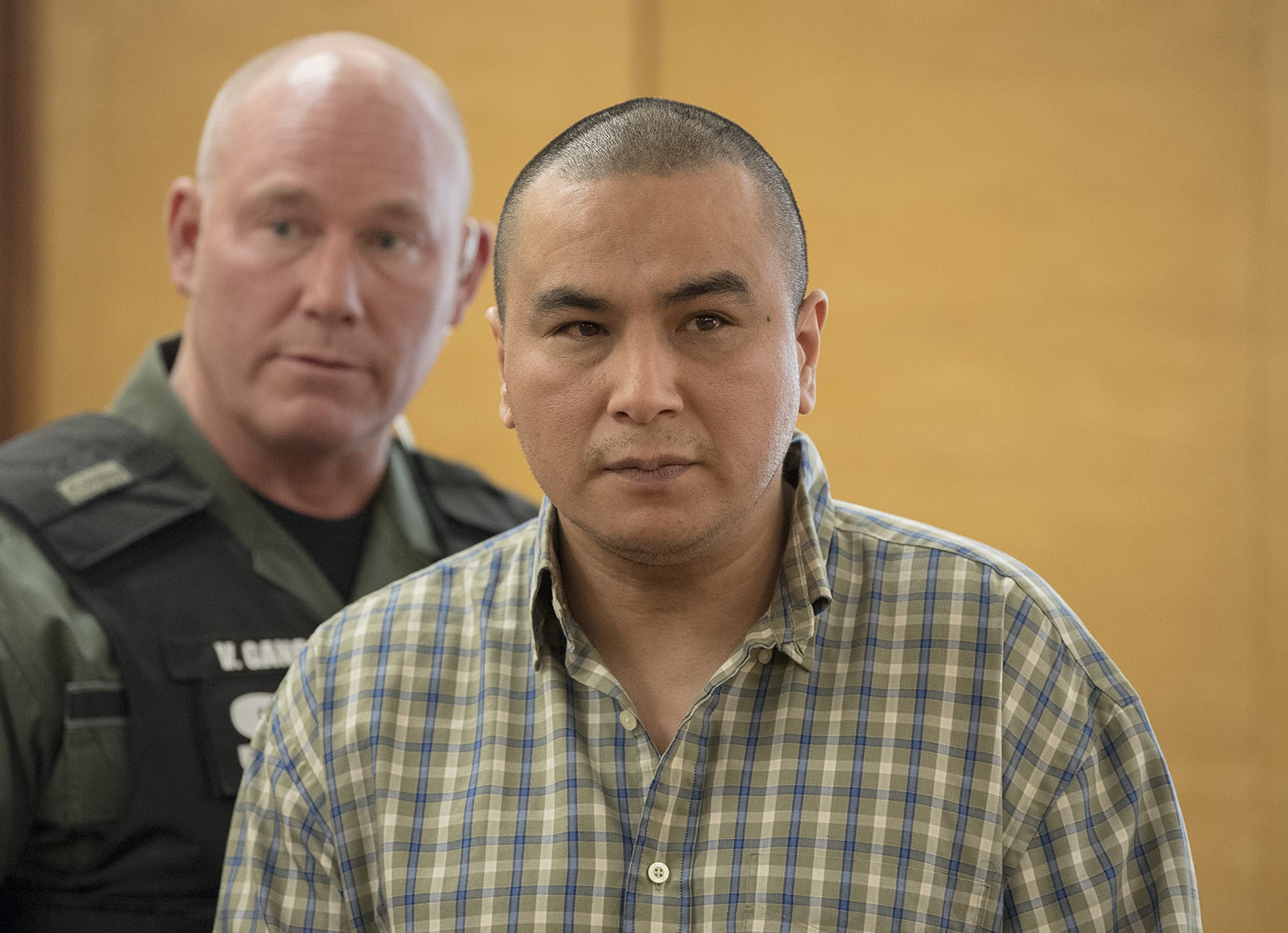 Ricardo Gutierrez Jr., in plaid, prepares to exit the courtroom after being found guilty of first-degree murder in the beating death of Jose "Pepe" Castillo-Cisneros, 3, with an aggravating factor that Pepe was a particularly vulnerable victim, in Clark County Superior Court on Thursday morning, Feb. 1, 2018. Gutierrez was sentenced Tuesday to 45 years in prison.