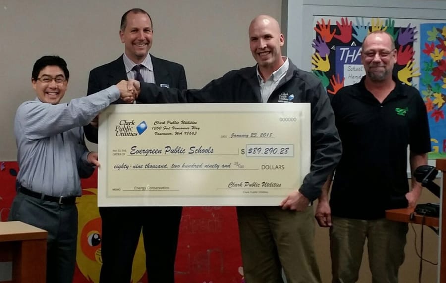 East Mill Plain: Clark Public Utilities gave Evergreen Public Schools a rebate check for energy upgrades in the district. From left: Todd Yuzuriha, president of the school board, Superintendent John Steach, Bill Hibbs, Clark Public Utilities commercial energy efficiency manager, and Jeff Taylor, manager with Columbia Electric Supply.
