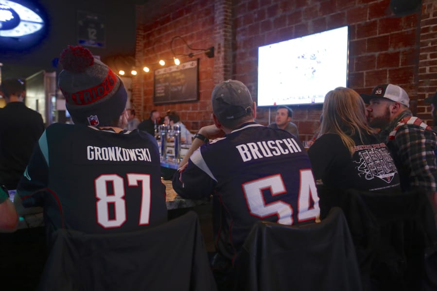 A group of New England Patriot fans watch the Super Bowl on Sunday afternoon at the Main Event Sports Grill in downtown Vancouver.