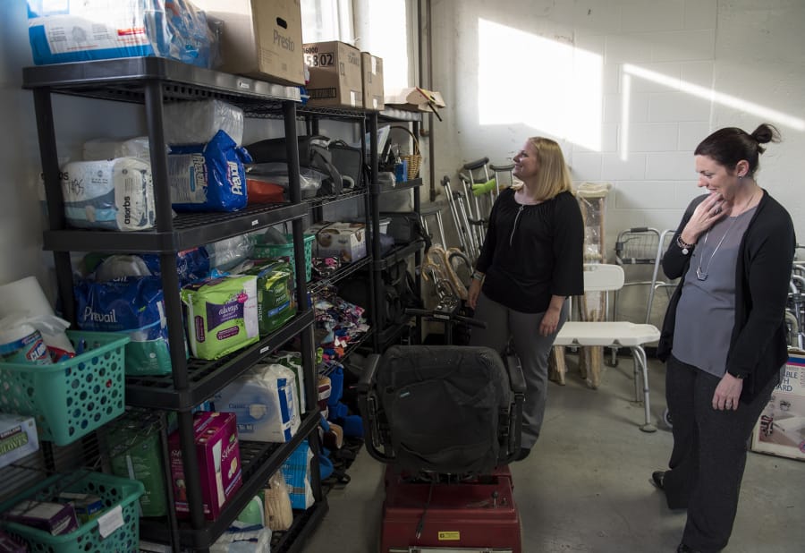 A Caring Closet co-founders Jodie Zelazny, left, and Sara Scheetz look over the variety of medical equipment they have available for those who need it. The nonprofit’s most requested items are wheelchairs, walkers, bath benches, adult briefs and scooters.