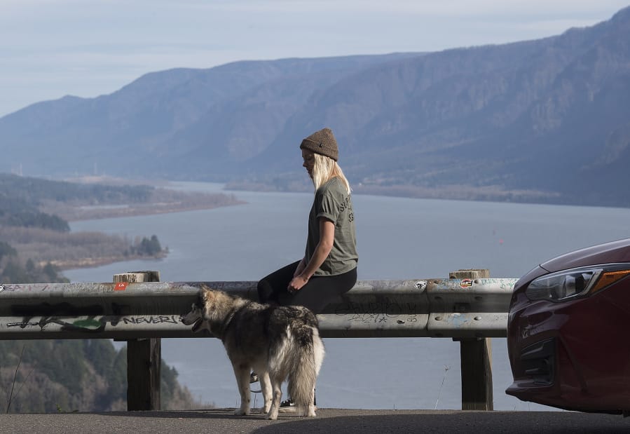 Sena Blevins and her dog, Kirra, takes in sweeping views of the Columbia River Gorge at the Cape Horn Lookout along state Highway 14. The U.S. Forest Service and the Columbia River Gorge Commission are now mulling changes to the Gorge’s National Scenic Area management plan that could have lasting implications for Gorge recreation enthusiasts and residents alike.