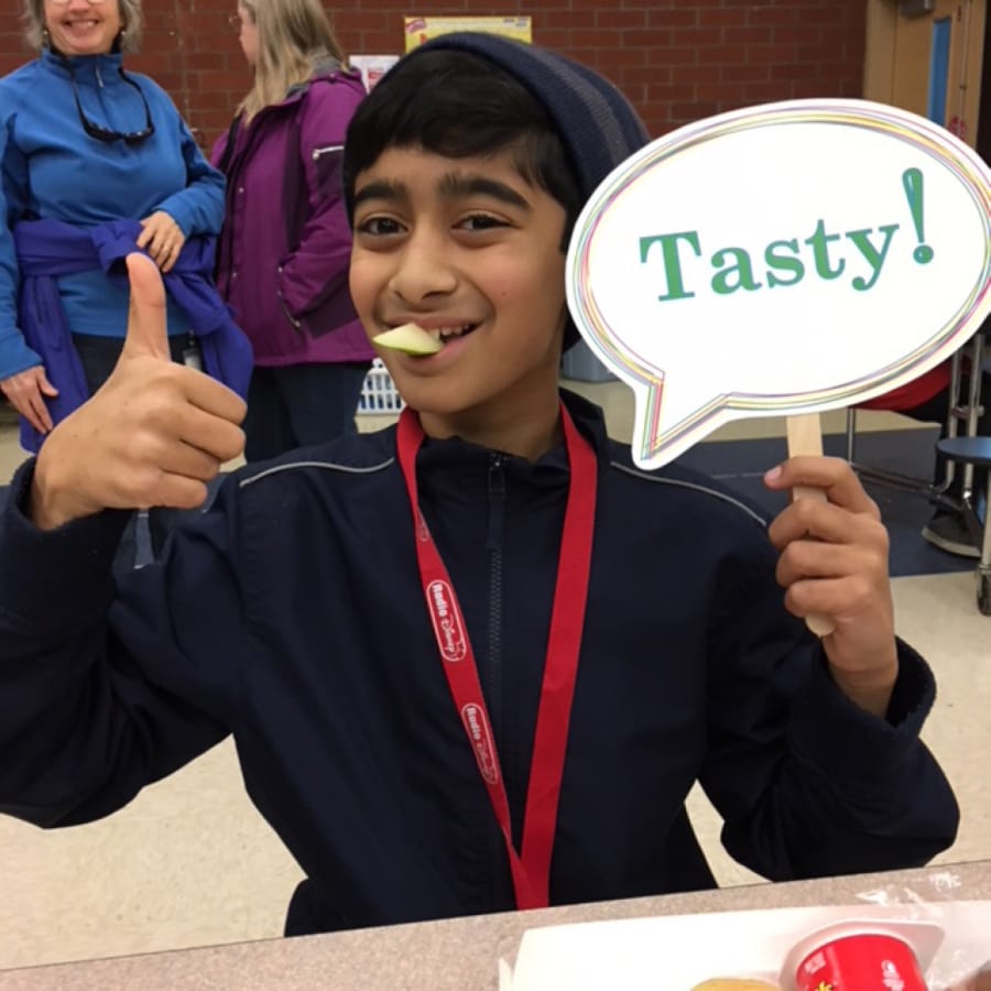 Orchards: Orchards Elementary School fourth-grader Suhayb Quddus tries pears as part of Washington State University Extension’s Supplemental Nutrition Assistance Program Education’s Harvest of the Month program.