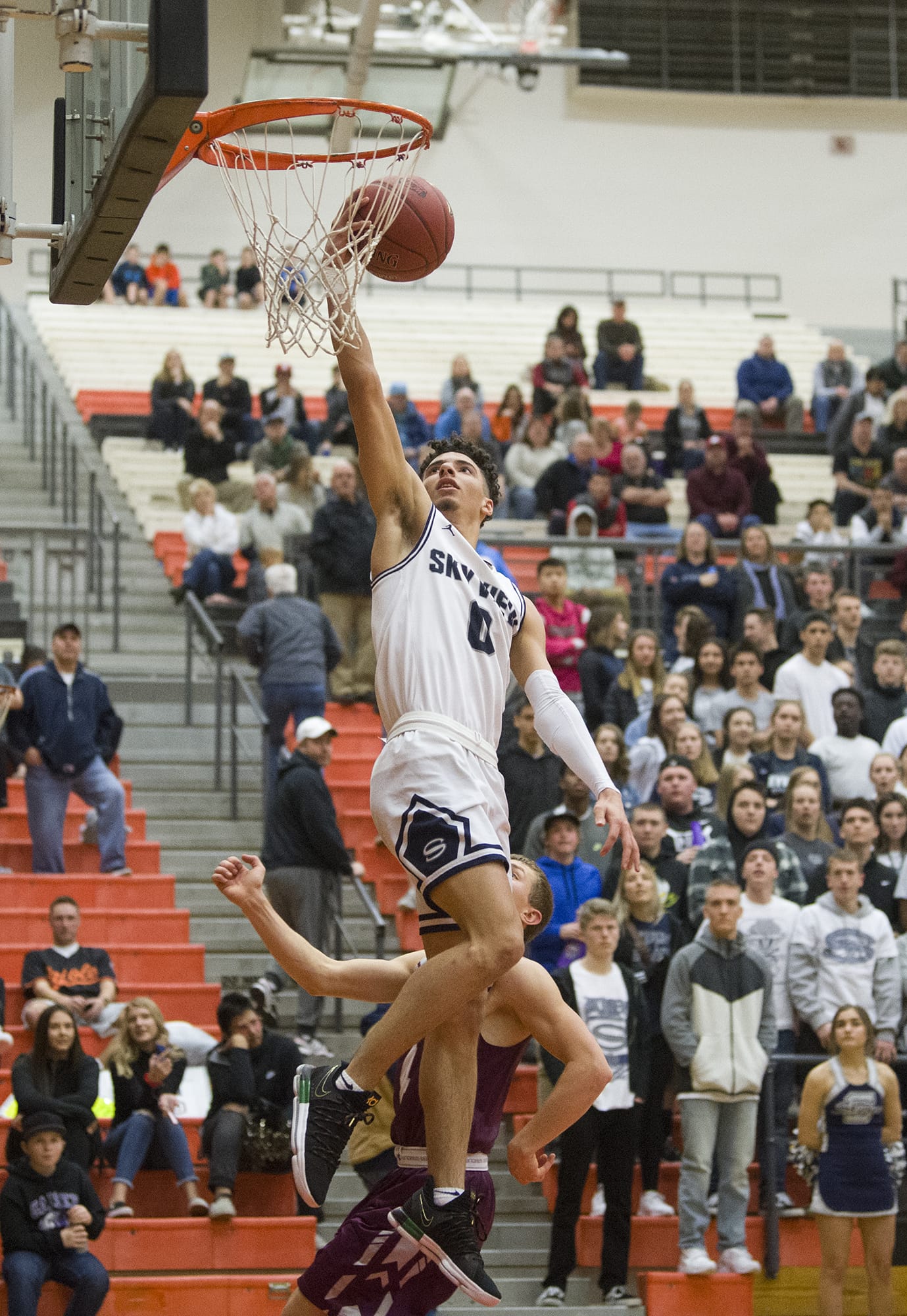 Skyview’s Alex Schumacher (0) goes up to dunk the ball during the 4A regional game against Enumclaw at Battle Ground High School, Saturday February 24, 2018.