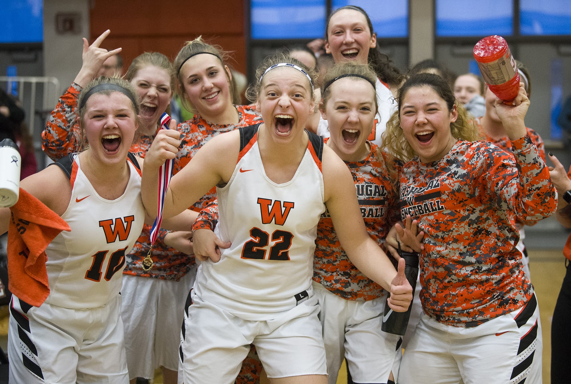 Washougal girls basketball players scream with excitement after receiving their medal for winning the 2A regional girls basketball game against Fife at Battle Ground High School, Saturday February 24, 2018.