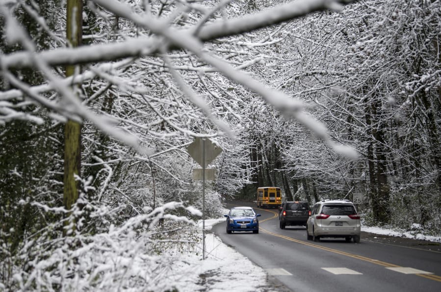Temperatures lingered just above freezing Thursday morning, so freeways and metro-area streets were mostly bare. Here, drivers are seen along Blandford Drive canyon from MacArthur Boulevard to Evergreen Boulevard late Thursday morning.