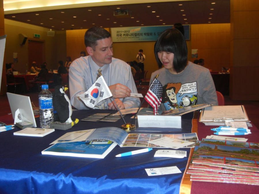 Vice President of Student Affairs Bill Belden talks with a prospective student in South Korea during a recruitment trip.