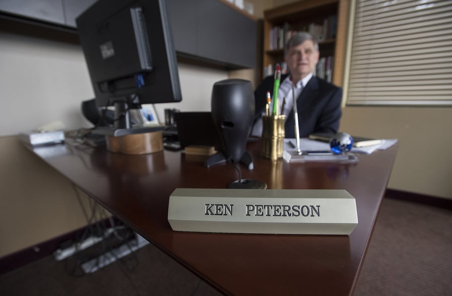 An aluminum ingot-turned-nameplate sits on the desk of Columbia Ventures Corporation CEO Ken Peterson. Peterson, 65, started the business in the aluminum industry, but it’s grown into other fields in recent years. Most recently, the firm led a $17 million fundraising round for local tech company RealWear.